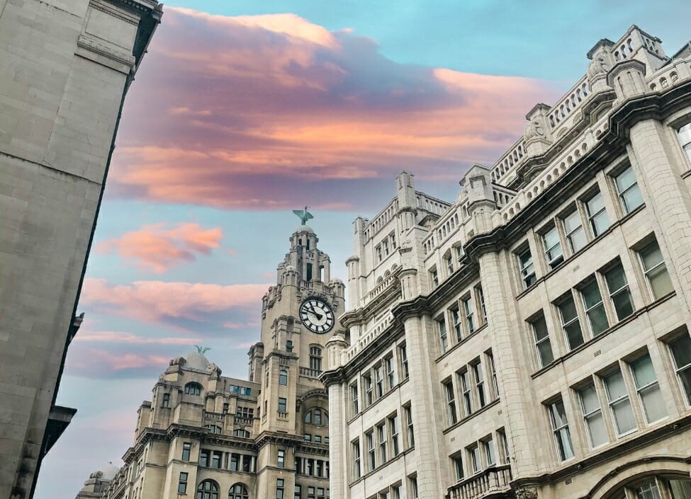 Liver Building in Liverpool, a stone building with a clock in the background and a cloudy sky