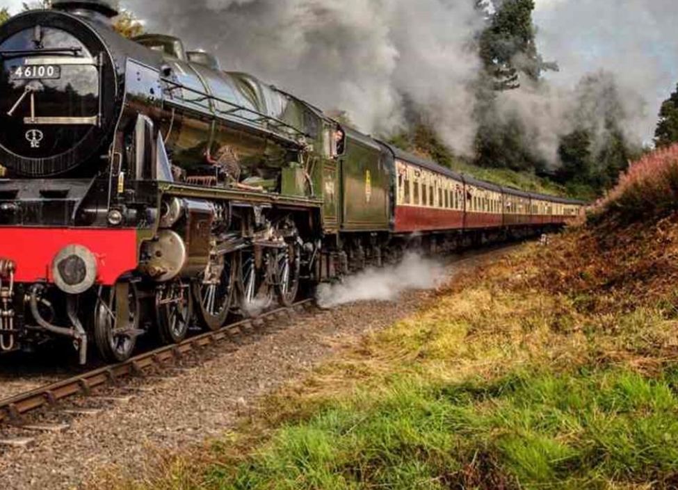 The Flying Scotsman, a black and red steam train passing through landscape