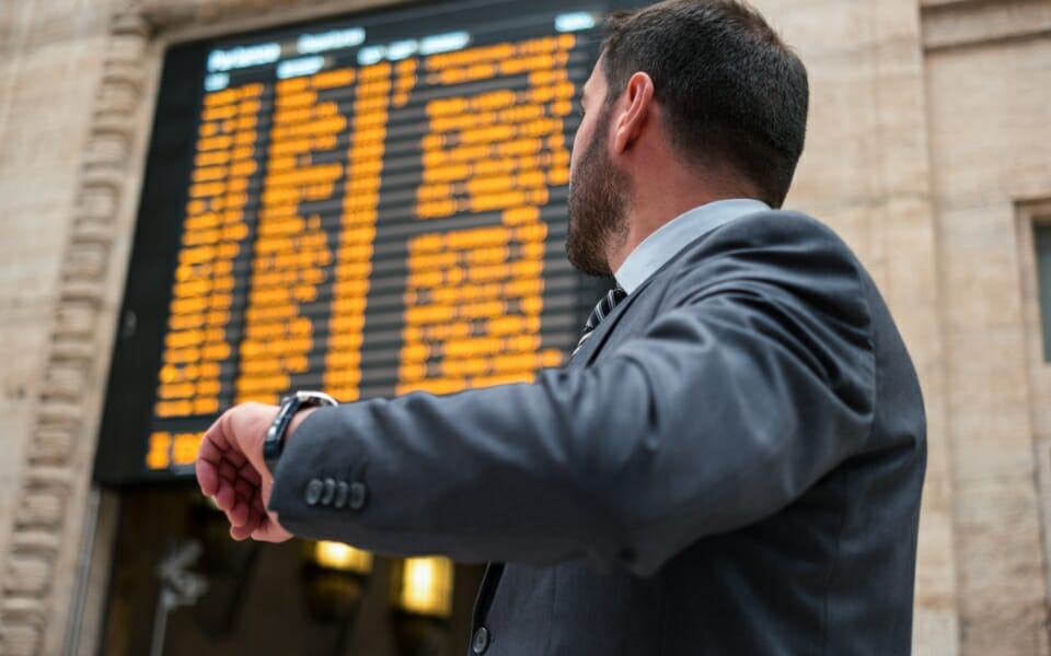 commuter checking train departure times at station