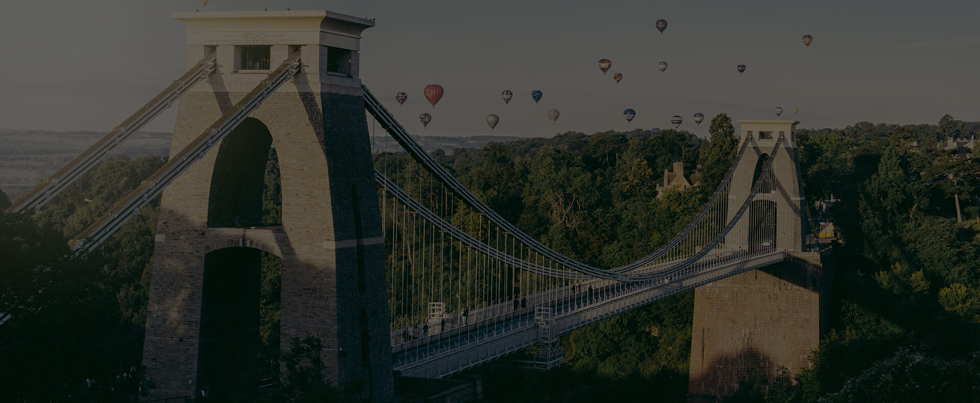 clifton suspension bridge bristol with trees and hot air balloons