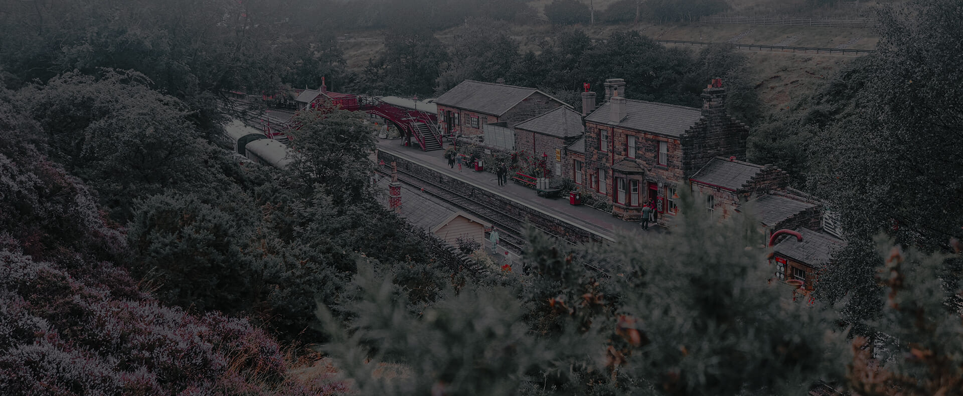 view of goathland station on british rail network with buildings and trees