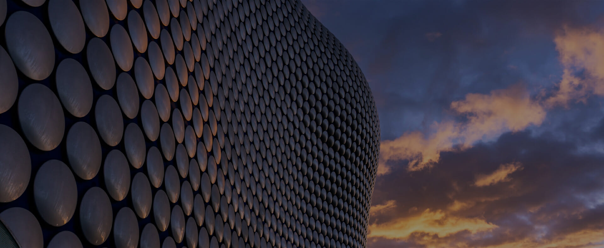 selfridges building in birmingham city with a cloudy sky