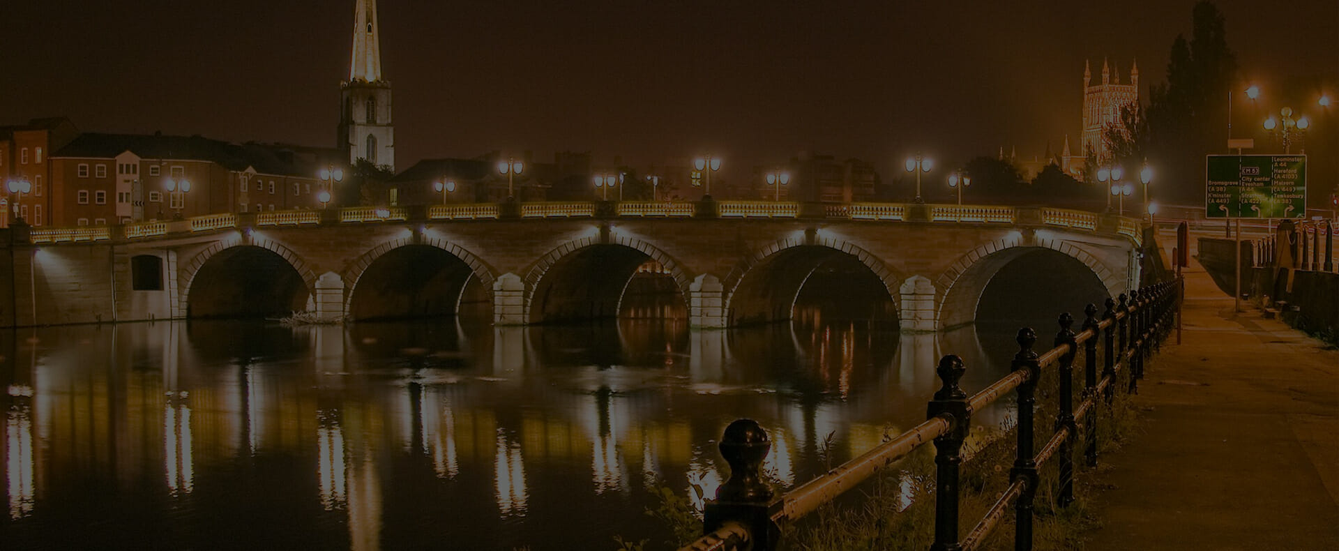 river severn with worcester cathedral in the background at nightime with streetlights on worcester bridge