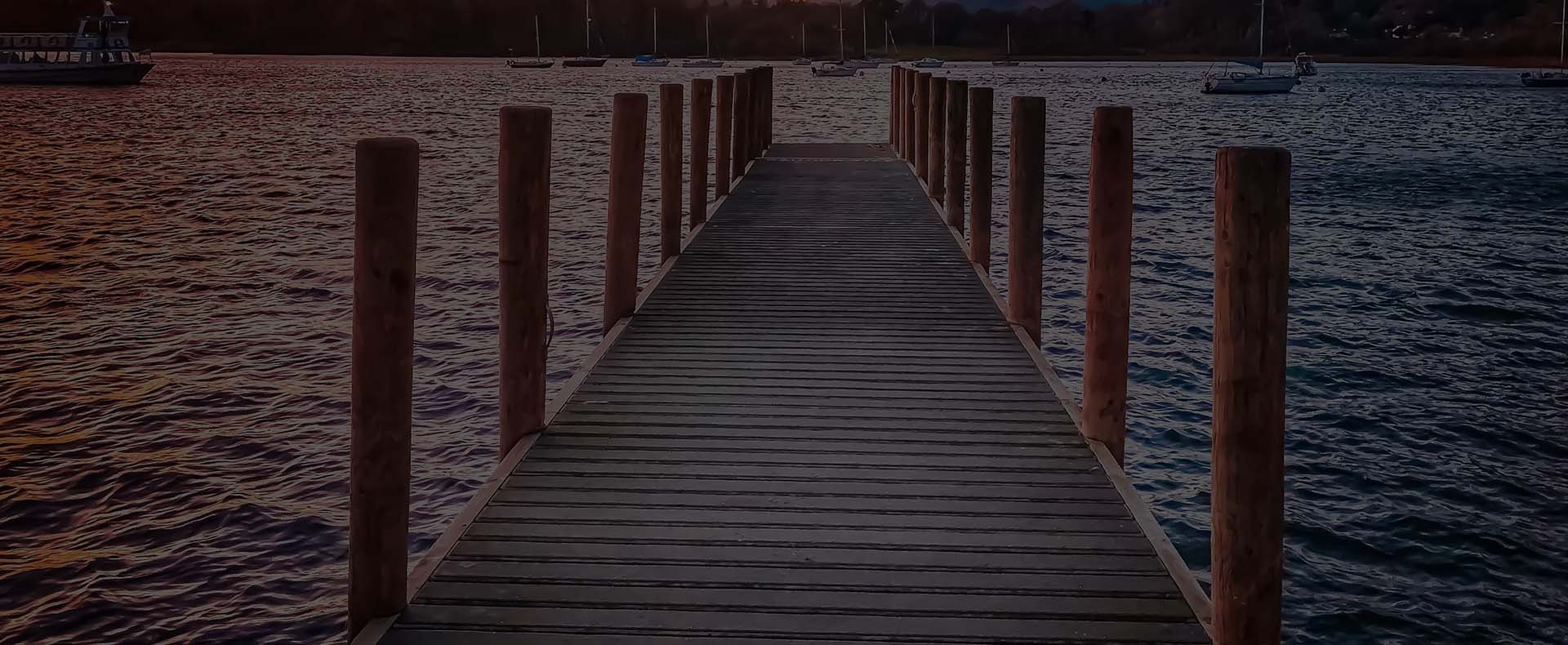 windermere lake district jetty with boats on the water