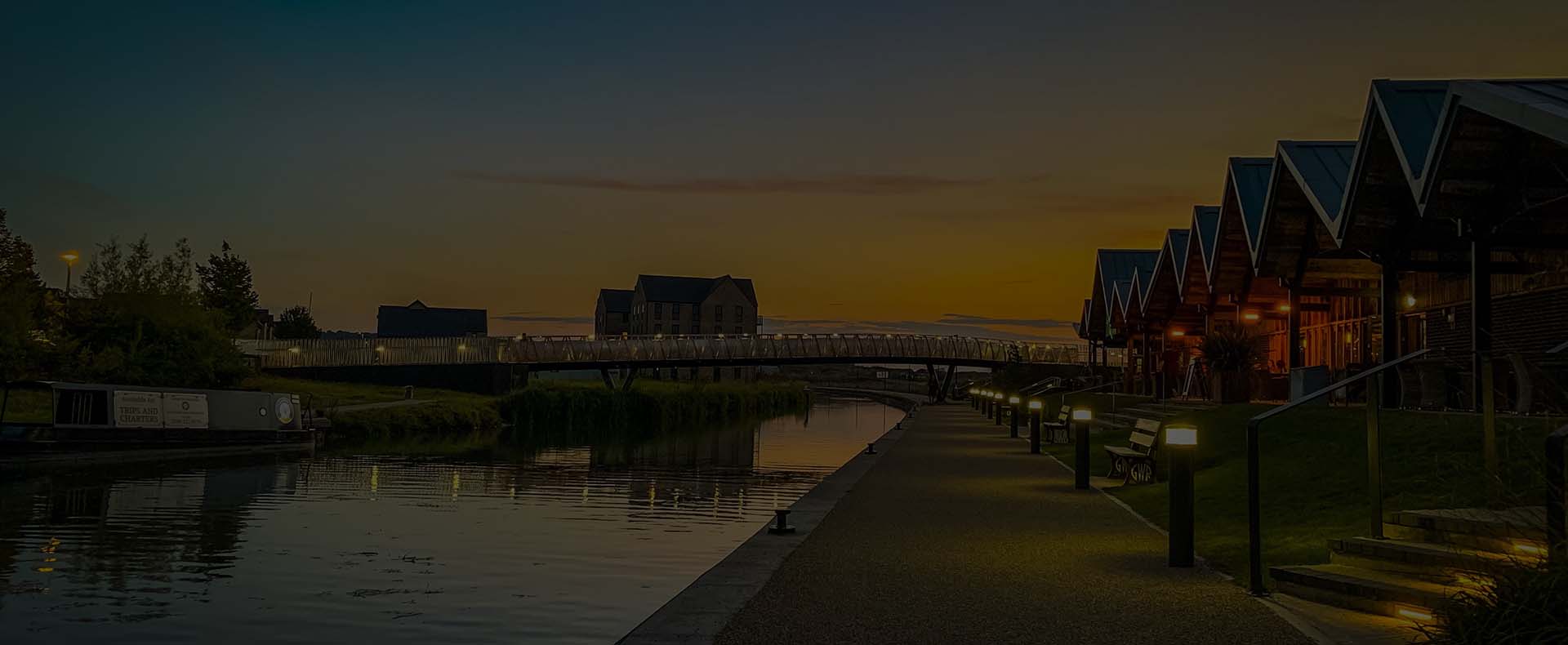 wichelstowe swindon houses by a footpath next to a river with a night sky