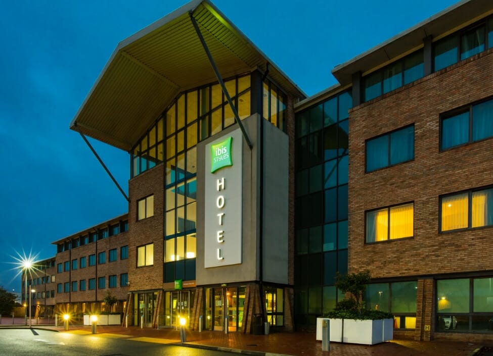 ibis Birmingham Airport NEC hotel building at night with numerous windows lit facing onto a street with lighting