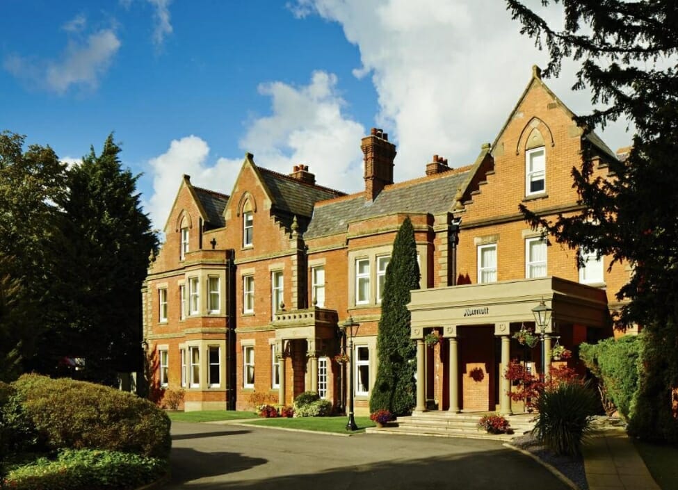 The Delta Hotels by Marriott Preston building, an old manor style house, with a drive and trees in front