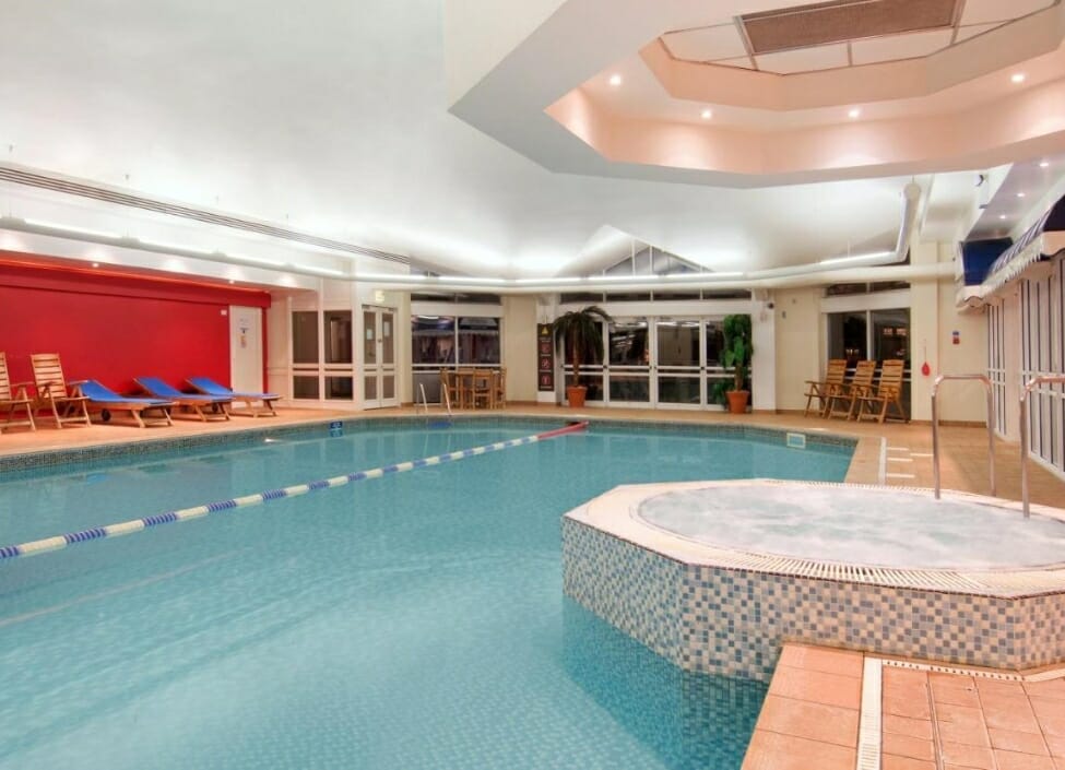 Hilton Leicester Hotel swimming pool with a jacuzzi and loungers and paving alongside