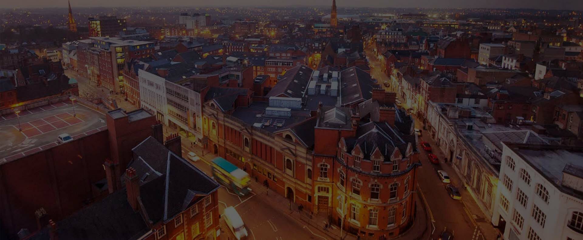 Aerial view of Leicester city centre at night with vehicles on the roads