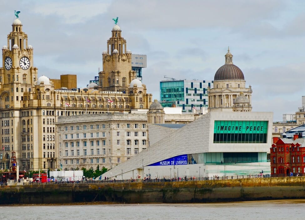 The Museum of Liverpool on Liverpool Waterfront, a modern building with tall limestone buildings behind it.