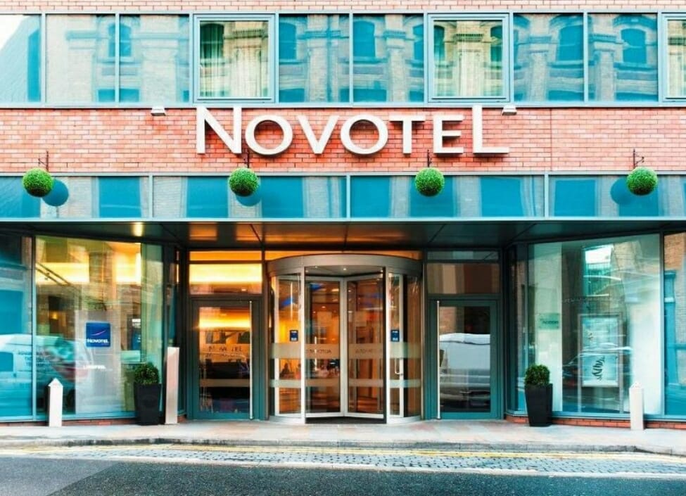Front of Novotel Liverpool Centre Hotel with a sign and lobby and a pavement and road in front