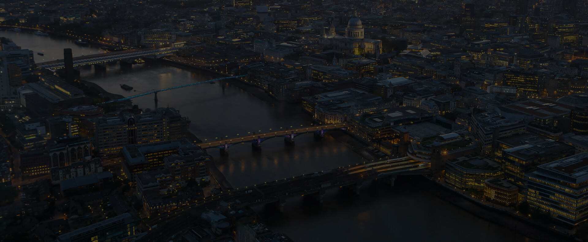 aerial view of london city with buildings and bridges over the river thames