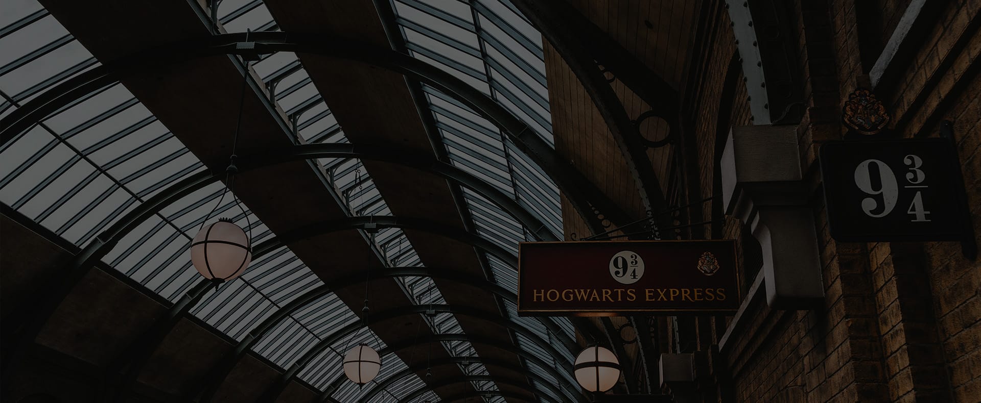 Platform nine and three quarters at Kings Cross Station with signage indicating the platform and windows above