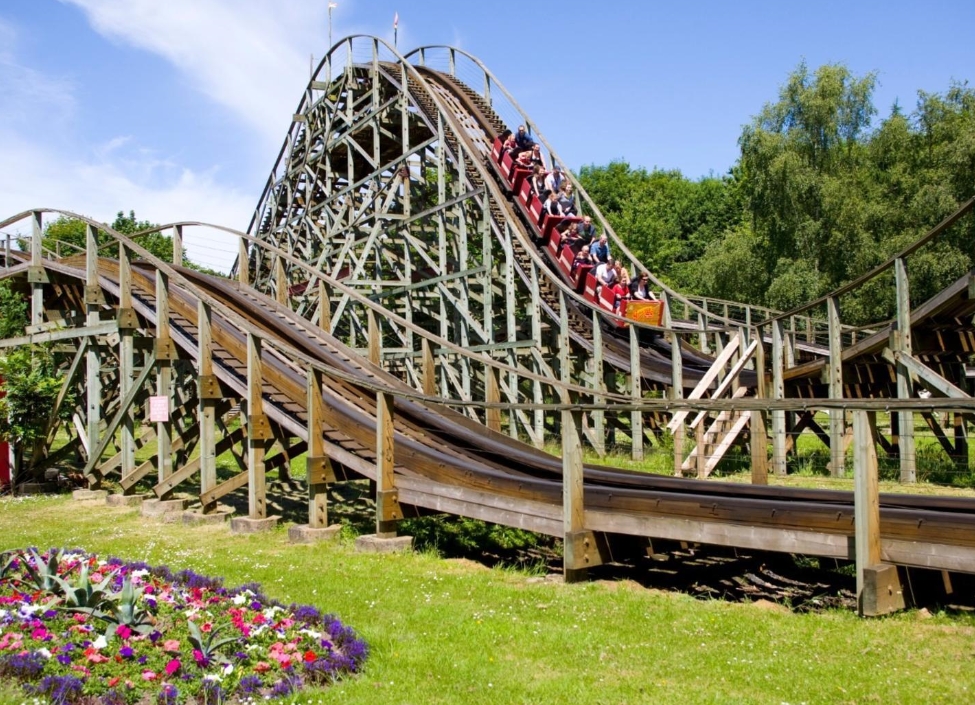 A rollercoaster at Gullivers World in Warrington with passengers on and grass in front