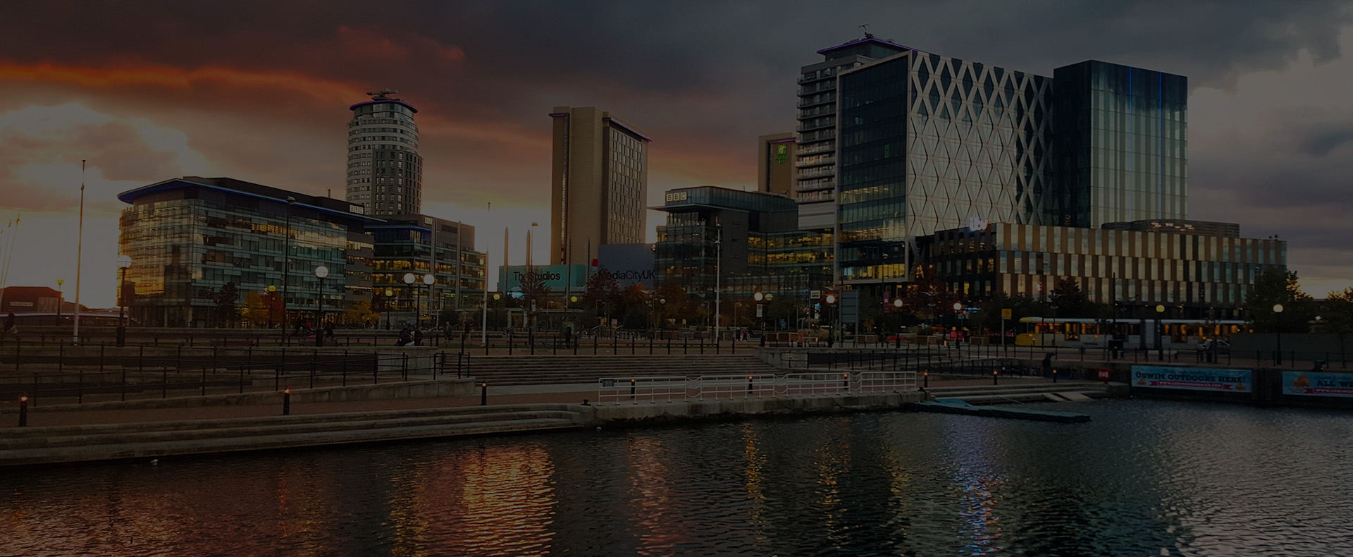 Media City on Salford quats, several tall metal buildings with water infront at dusk